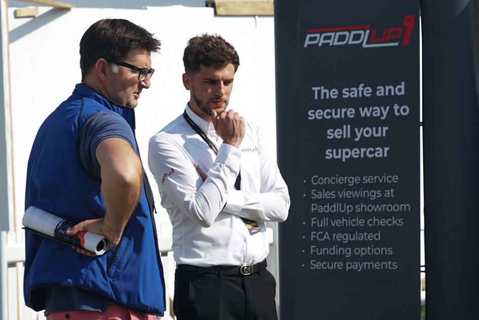 One of the PaddlUp consignment team discussing our range of supercars with a client