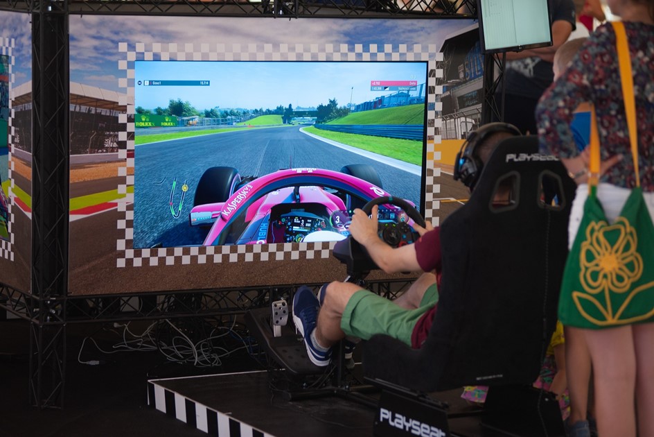A Ferrari F1 car being driven on a Formula 1 game simulator