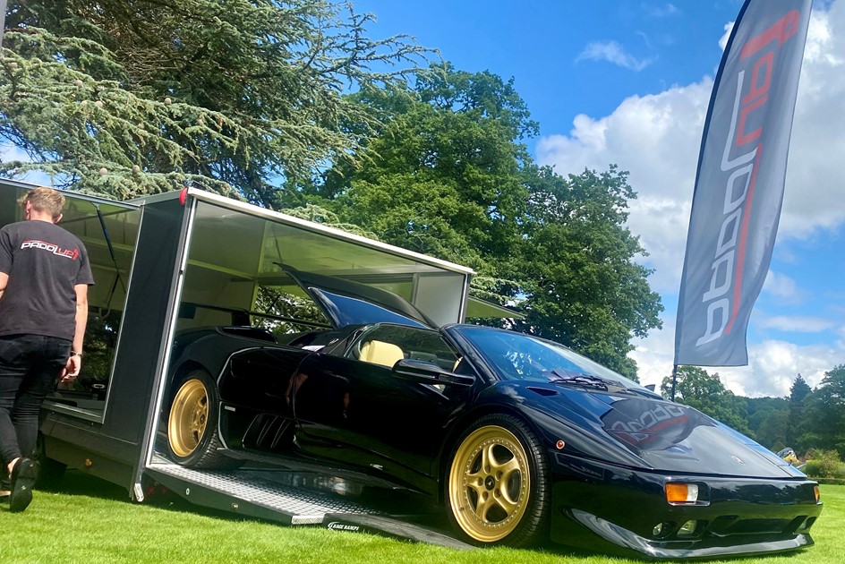 A classic supercar being unloaded from one of PaddlUp's enclosed trailers at Grantley Hall