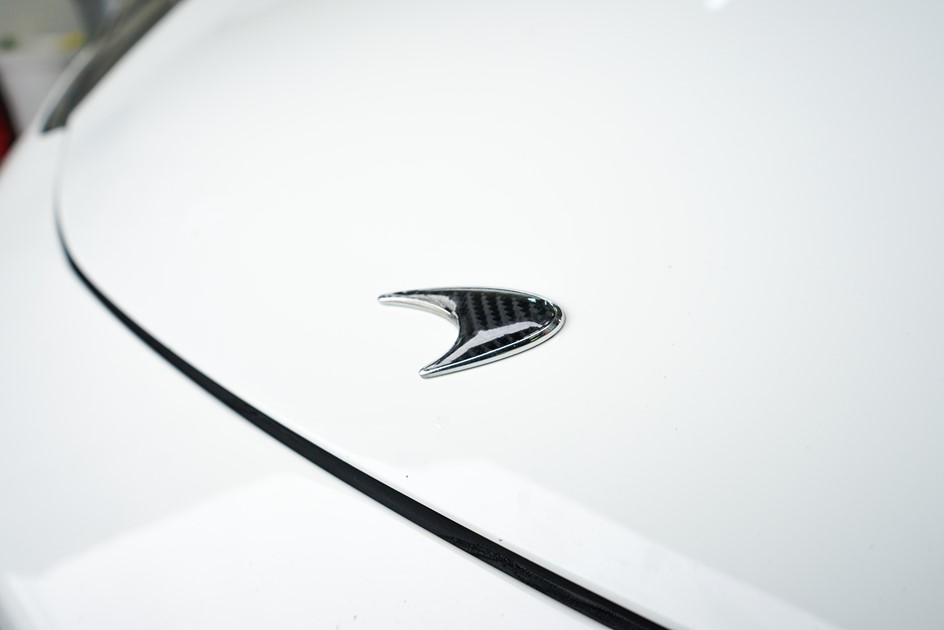 A close-up of the badge on a white McLaren's MP4-12C