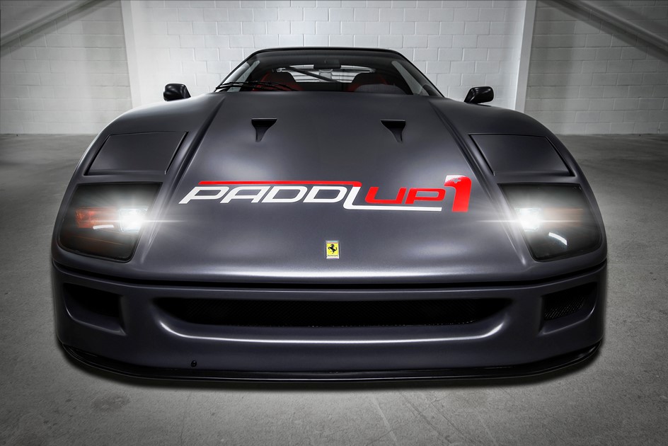 A Ferrari F40 wrapped with the PaddlUp logo in a studio
